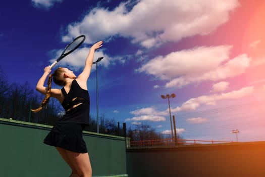 Happy beautiful sexy girl playing tennis on the court. Sport and recreation, leisure.