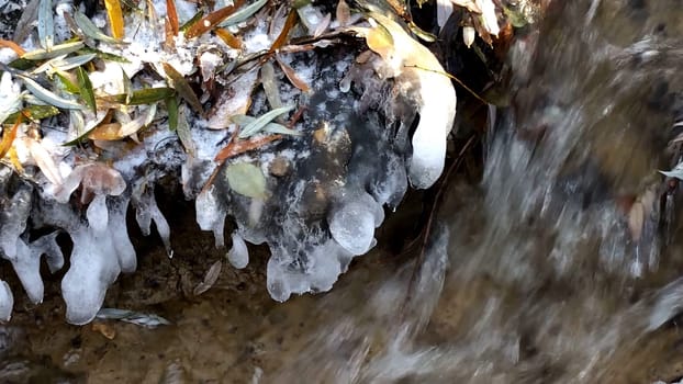 little creek in winter with icicles