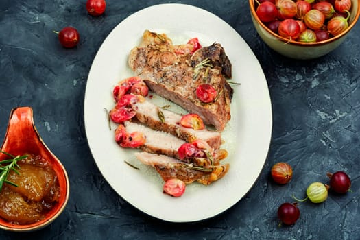 Delicious grilled beef steak with gooseberry, barbecue.