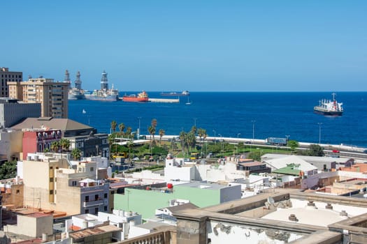 Panoramic view from above of the capital and part of the harbor in Las Palmas Gran Canaria in Spain with blue sky