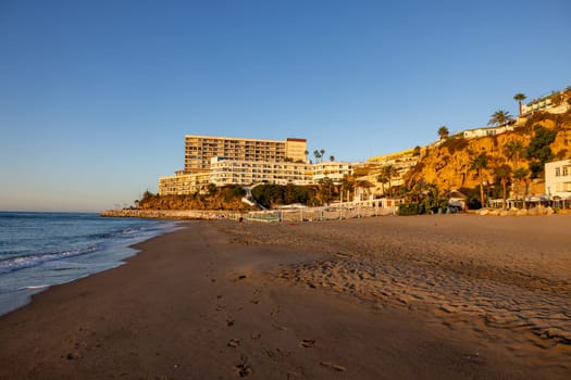 View of Bajondillo Beach and hotels in Torremolinos at sunrise. Costa del Sol, Spain.