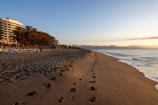 Torremolinos, Spain - September 12, 2023: View of Bajondillo Beach and hotels in Torremolinos at sunrise. Costa del Sol, Spain.