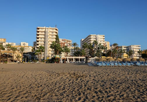 Torremolinos, Spain - September 12, 2023: View of Bajondillo Beach and hotels in Torremolinos at sunrise. Costa del Sol, Spain.