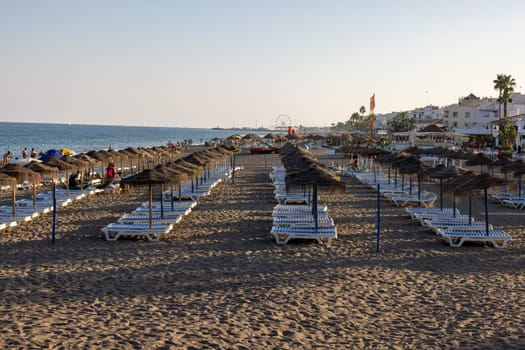 Torremolinos, Spain - September 9, 2023: People relaxing on La Carihuela beach in Torremolinos, Malaga, Costa del Sol, Spain