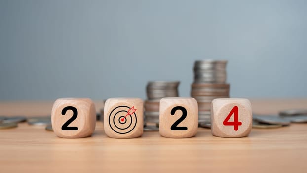 Wooden blocks lined up with the letters 2024, Represents the goal setting for 2024, the concept of a start, financial planning development strategy business goal setting, Budget, tax, investment.