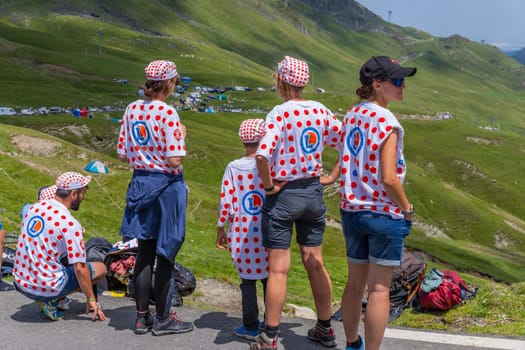 Col du Tourmalet, France - July 06 2023: Cycling fans waiting for the buch at the top of the Col du Tourmalet in Pyerenees mountains during the stage 6 of Le Tour de France 2023