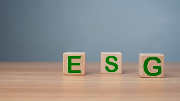 ESG concept of environmental, social and governance, wood block and icon on wooden background It is an idea for sustainable organizational development ​account the green environment.