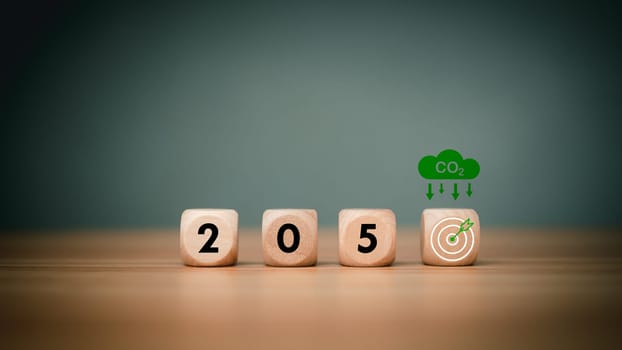 Wooden cubes with net zero icon in 2050 on wooden background, Net zero by 2050, Carbon neutral, Net zero green house gas emissions target, Climate neutral long term strategy, No toxic gases.