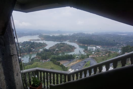 View from the staircase of the rock of Guatape, El Penon de Guatape on the surrounding lake landscape close to Medellin, Colombia 2020