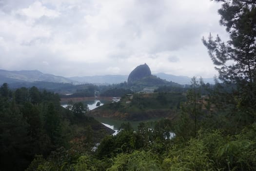 View on the Rock of Guatape, El Penon de Guatape close to Medellin from far, Colombia 2020