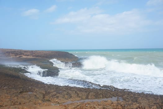 Cliff and splashing waves in Cabo de la Vela, La Guajira, Colombia 2020