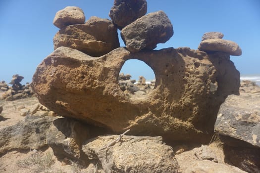 Hole in a rock formation showing stone pillars at Punta Gallinas, La Guajira, Colombia 2020