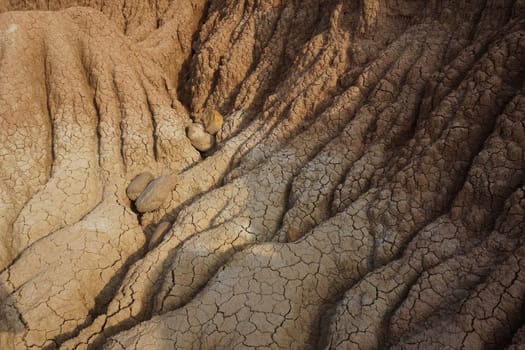 Dired out soil on the red and yellow rock formations in the Tatacoa Desert, Desierto de la Tatacoa, Colombia 2020