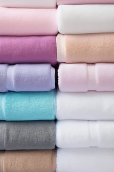 Stack of folded Towels on bright background. artificial art