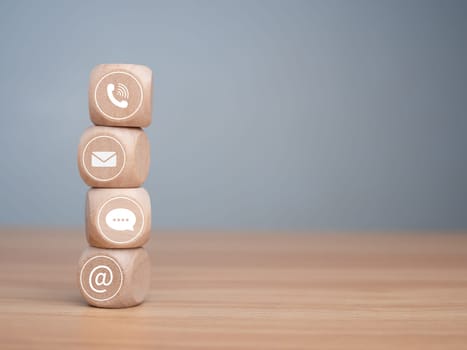 Website page contact us or e-mail marketing concept, Customer support hotline Contact us people connection. phone, email, address and chat message icon on wooden blocks, marketing online concept.