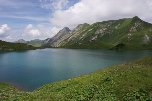 Picturesque view onto lake Schrecksee in the german Alps in spring time, Allgäu, Germany 2020
