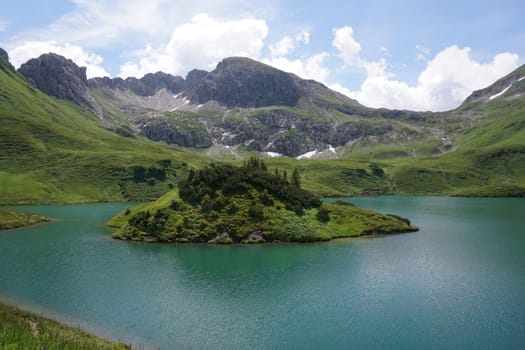 Spectacular view on the little island in the middle of the lake Schrecksee in the german Alps, Allgäu, Germany 2020