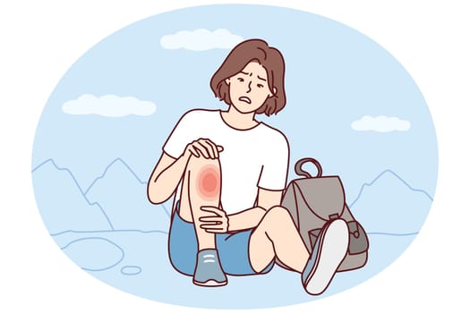 Weakened woman sits on ground with fear looks at wound on leg after fall during walk. Traveler girl was injured during hike and needs healing ointment or dressing of fracture site. Flat vector image