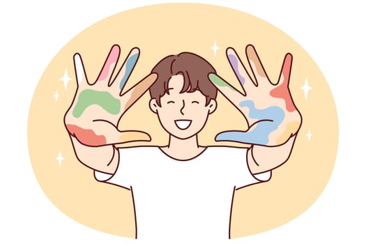 Positive guy stretches arms forward showing remains of multi-colored spots after drawing lesson. Creative boy in white t-shirt shows palms after experimenting with art. Flat vector illustration