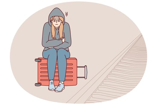 Tired woman sits on suitcase near railway waiting for train and is sad because of lack of money for ticket. Unhappy girl in hood missed train freezes at station alone. Flat vector illustration