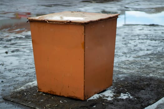 Orange Steel Tank. Sand tank. Dumpster in the city. Technical capacity for materials.