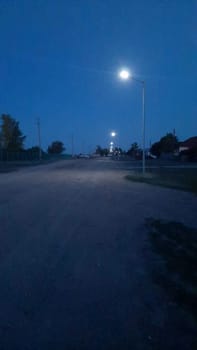 night road in lighting solar powered lanterns. High quality photo for social network.