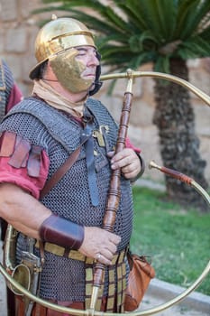 Merida, Spain - June 3th, 2023: Roman war-trumpeter performing. Emerita Ludica Festival 2023, Merida, Spain