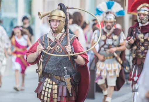 Merida, Spain - June 3th, 2023: Roman war-trumpeter performing. Emerita Ludica Festival 2023, Merida, Spain
