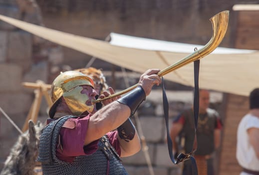 Merida, Spain - June 4th, 2023: Roman war-trumpeter performing. Emerita Ludica Festival 2023, Merida, Spain