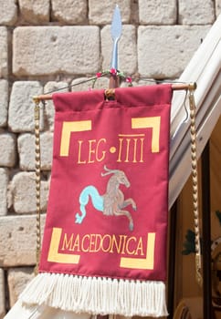 Merida, Spain - June 4th, 2023: Vexillum, roman military standard beside legionary officer tent. Emerita Ludica Festival 2023, Merida, Spain