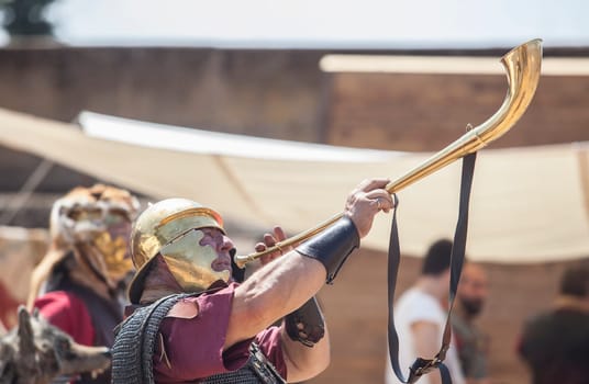 Merida, Spain - June 4th, 2023: Roman war-trumpeter performing. Emerita Ludica Festival 2023, Merida, Spain