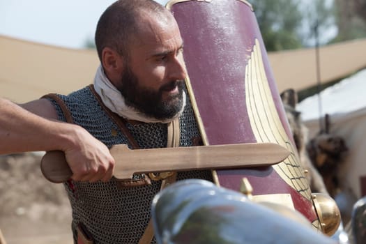 Merida, Spain - Oct 9th, 2021: Roman soldier wielding a wooden training sword. Emerita Ludica Festival 2021, Merida, Spain