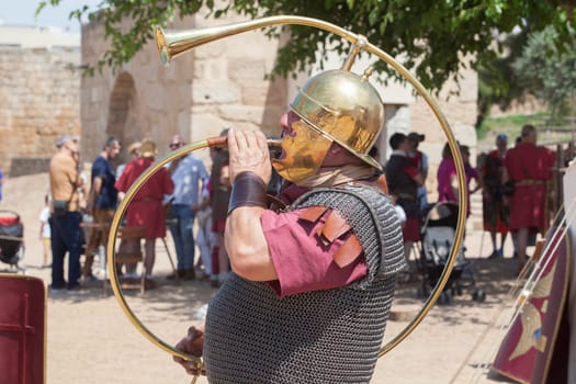 Merida, Spain - June 4th, 2023: Roman war-trumpeter performing. Emerita Ludica Festival 2023, Merida, Spain