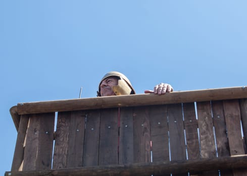 Merida, Spain - June 4h, 2023:  Reenactor over watchtower of a roman camp or fectio. Emerita Ludica Festival 2023, Merida, Spain