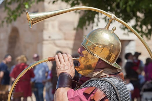 Merida, Spain - June 4th, 2023: Roman war-trumpeter performing. Emerita Ludica Festival 2023, Merida, Spain
