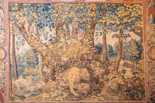 Isola Bella, Italy - 1 August 2023: detail of antique Italian tapestry in Borromeo Palace. Ancient decoration on indoor walls, fantasy creature