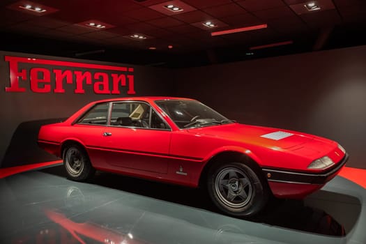 Turin, Italy - 11 november 2023: Car Museum. Red Ferrari 365 GT4, 1973. Italian design, luxury vintage car