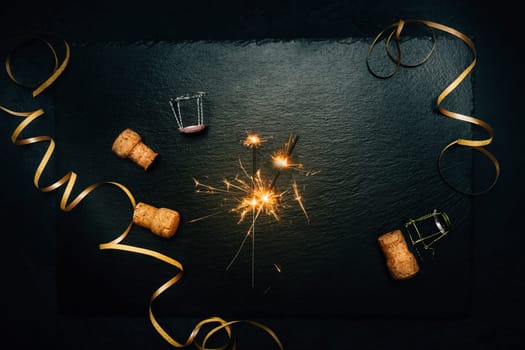 Happy New Year - celebration with sparkler, streamer on black background