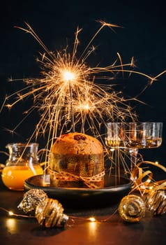Traditional Christmas panettone with chocolate, traditional Italian cake for Christmas with sparkler