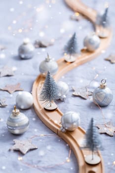 Festive table decoration with wooden railway for winter and Christmas, dining table  with ornaments