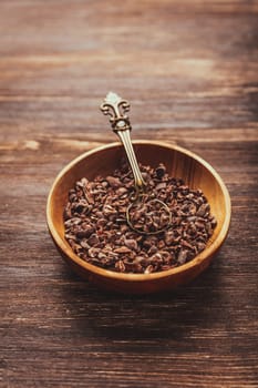 Cocoa bean nibs  in small bowl - baking ingredients