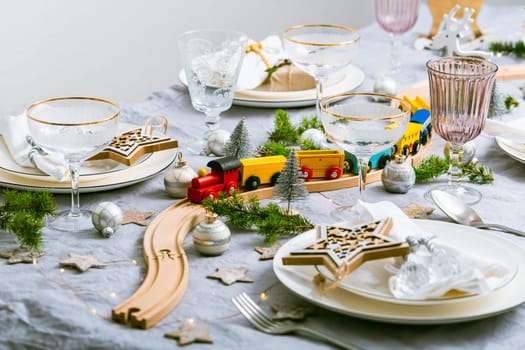 Festive Chriustmas place setting with small wooden railway