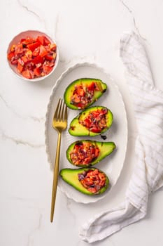 Avocados filled with bruschetta and balsamic vinaigrette - vegan appetizers