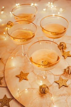 Happy New Year celebration, glasses of champagne, streamers and ornaments