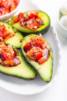 Avocados filled with bruschetta and balsamic vinaigrette - vegan appetizers