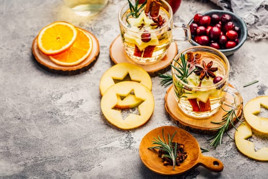 Delicious white mulled wine with apples, cranberries and spices