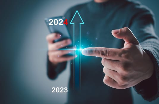 Hand man touch on virtual bar status to change from 2023 to 2024, countdown of merry Christmas and happy new year by technology concept, start new business and new life. New year's start-up.