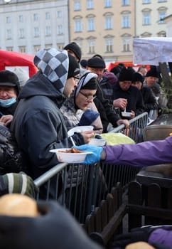 Krakow, Poland - Dec 17, 2023: Christmas Eve for poor and homeless on the Main Square in Cracow. The group Kosciuszko prepares the greatest eve in the open air in Krakow