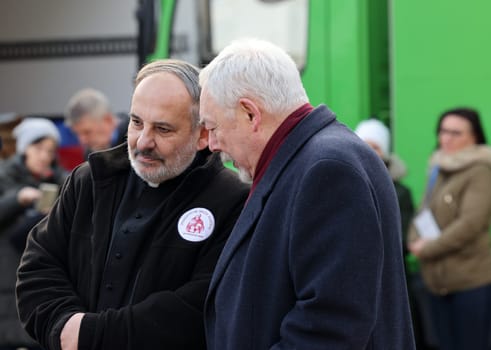 Krakow, Poland - Dec 17, 2023: Priest Tadeusz Isakowicz-Zaleski and Jacek Majchrowski at the Main Square during the Christmas Eve for poor and homeless