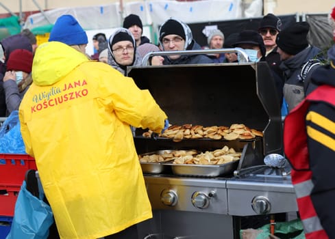 Krakow, Poland - Dec 17, 2023: Christmas Eve for poor and homeless on the Main Square in Cracow. The group Kosciuszko prepares the greatest eve in the open air in Krakow